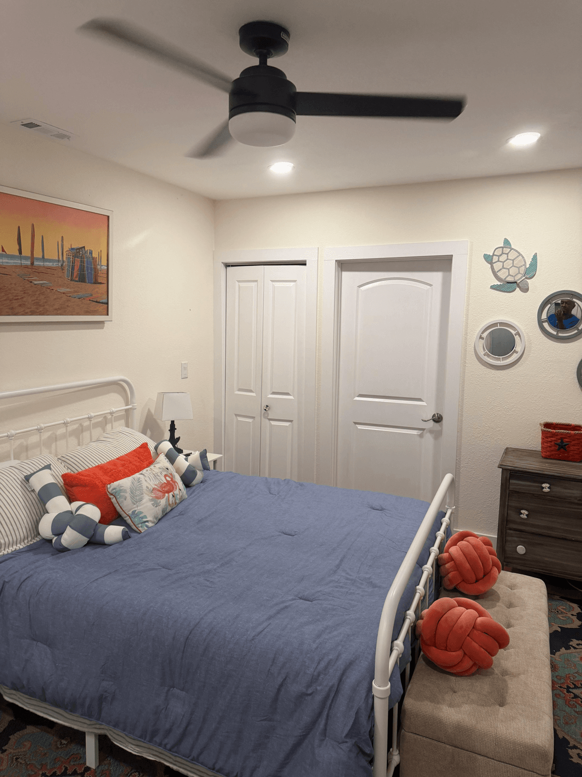 Guest bedroom with blue and coral coastal accents